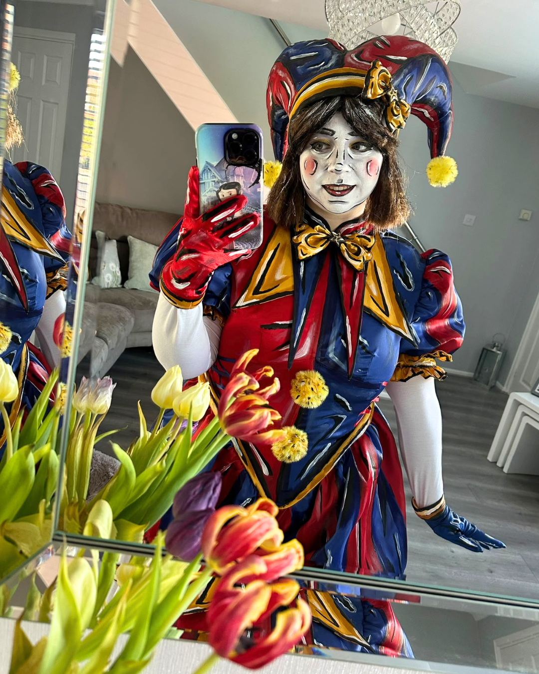 Celshaded Pomni cosplayer taking a mirror selfie with flowers